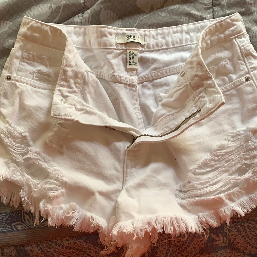 Distressed and frayed white booty shorts